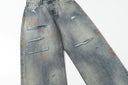 Ancellm Distressed Rust-Stained Jeans — Vintage Wash